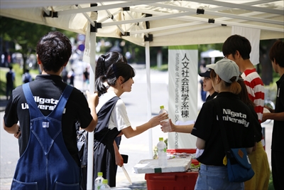 飲み物を渡す在学生